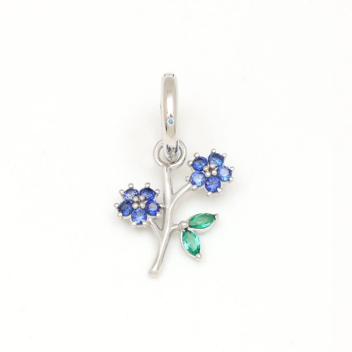 DIVETIA Blossom charm with lab-grown sapphire in rhodium-finished sterling silver, front view