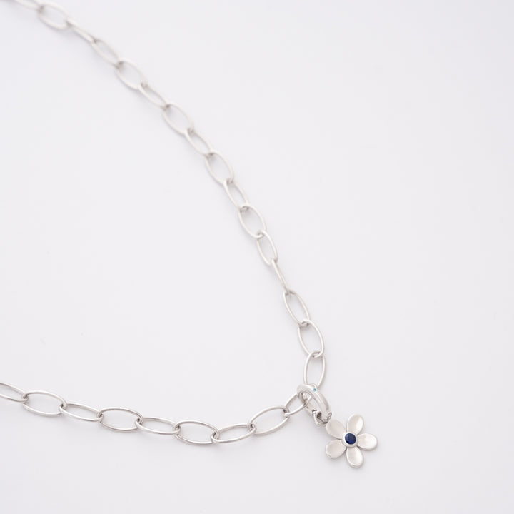 Daisy Day sapphire charm on the DIVETIA Rolo Necklace