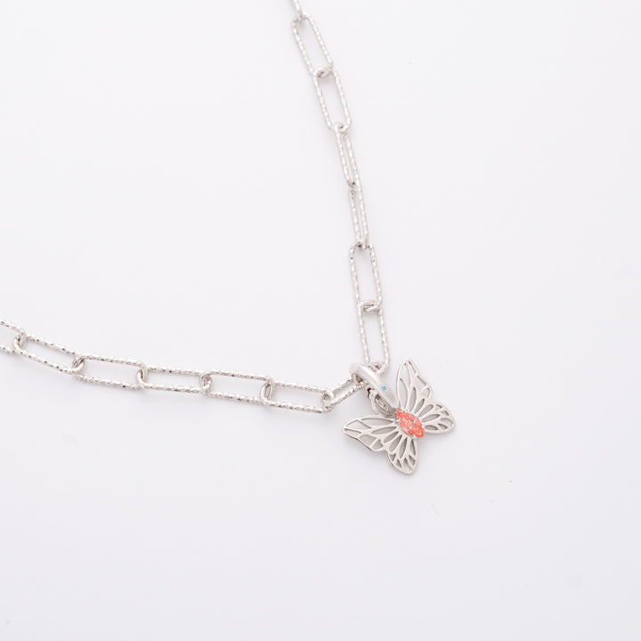 Flutter pink diamond charm on the DIVETIA Paperclip Necklace